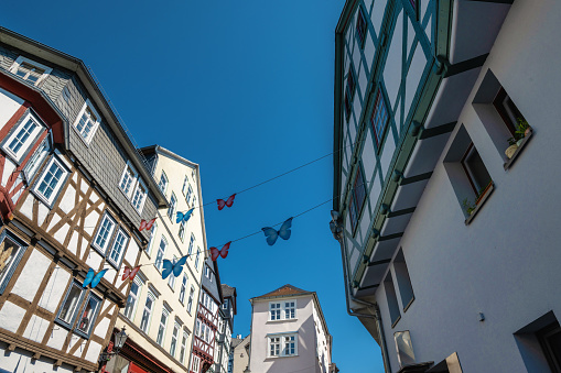 low angle view on colorful half-timbered  houses in Marburg under blue summer sky
