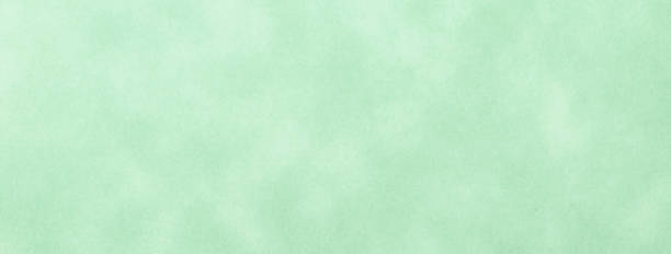 Texture of light green old paper, crumpled background. Vintage olive grunge surface backdrop.