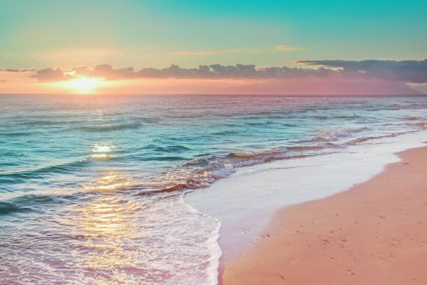 istock Colorful sunset viewed from the pink sea beach with soft waves 2151229272