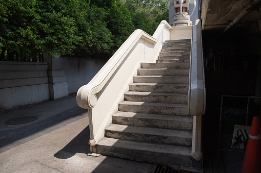 The cement staircase is more than 50 years old and has the style of a retro style railing.