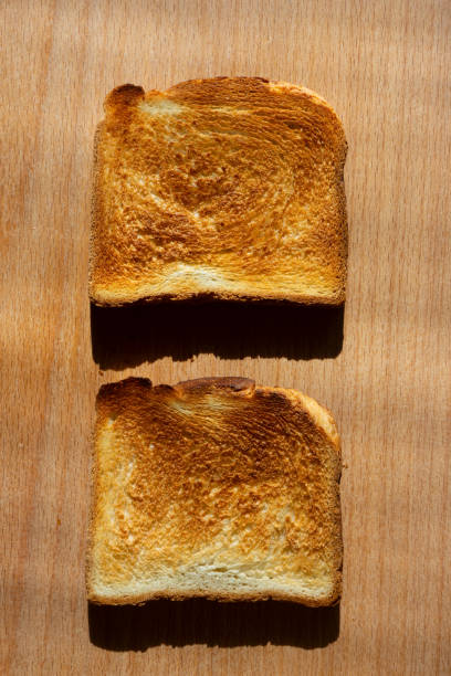 istock One pair of fried toast  lies on an oak board. 2151232521