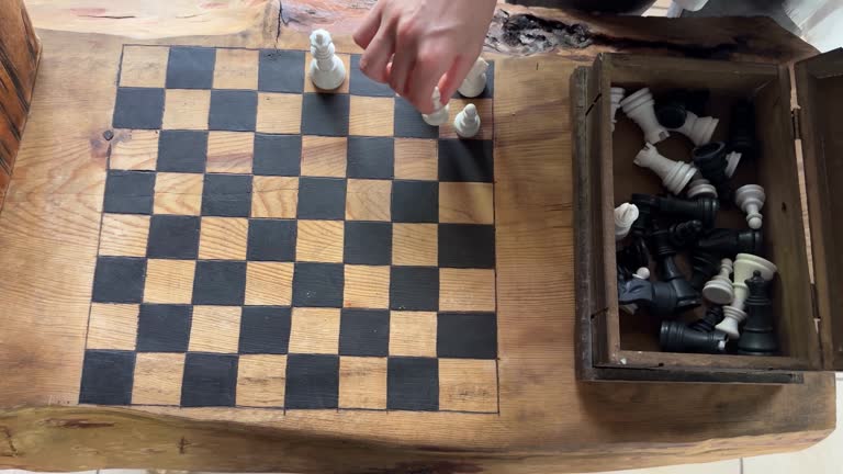 4k video footage of an unrecognizable person playing chess