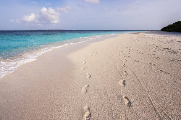 Footprints on tropical beach in the Maldives Islands