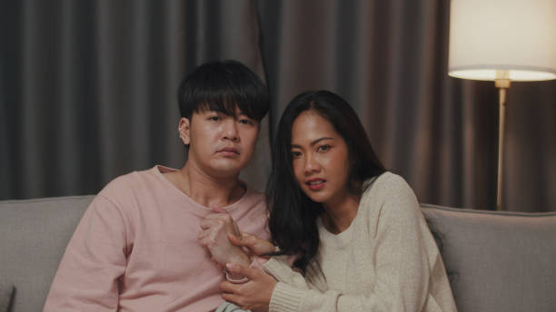 istock Concerned Couple Watching Intense Movie Scene. 2151237705