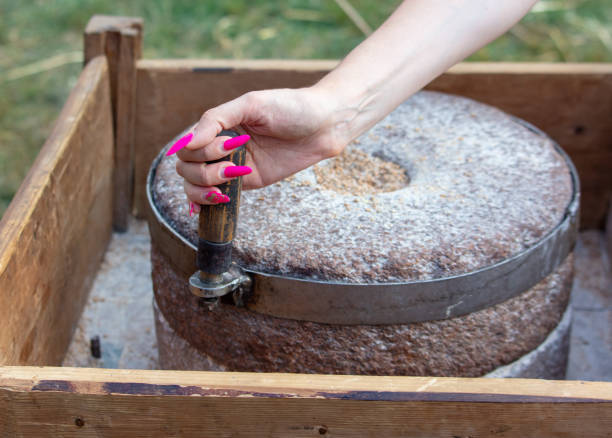 istock A girl grinds flour from a stone to marry 2151238042