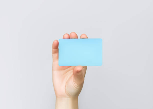 istock hand holding a blue plastic card on a grey background 2151238374