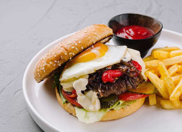 istock Appetizing gourmet burger with fried egg and fries 2151239094