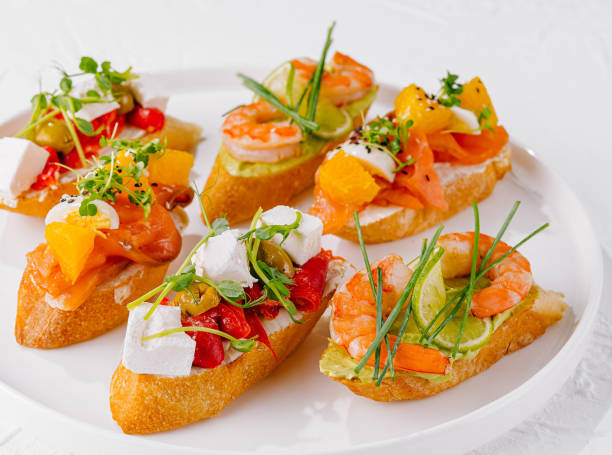 istock Elegant platter of assorted bruschetta with fresh toppings on a white background 2151239255