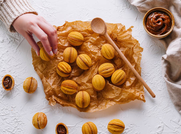 istock Hand picking a homemade walnut cookie 2151239264