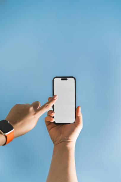 istock Woman’s hand holding phone mobile and touching screen 2151239335