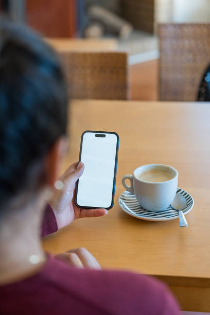 istock Woman uses his smart phone with blank screen 2151239360