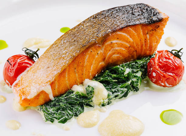 istock Gourmet grilled salmon with spinach and tomatoes 2151239366