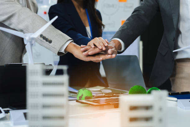 istock business people holding each others wrists, join hands together, support and unity, team strength and power, colleagues involved in team building activity. 2151241185