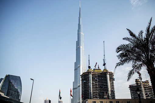Dubai, United Arab Emirates - January 23, 2016: It is the tallest building in the world, standing at 828 meters in Dubai. It features a sleek, tapering design inspired by Islamic architecture. The skyscraper houses luxury residences, offices, and a hotel, along with observation decks offering stunning views. Its iconic status symbolizes Dubai's modernity and ambition.