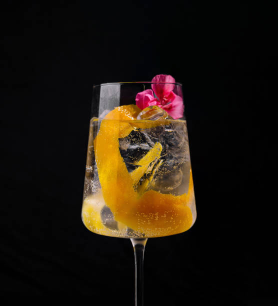 istock Exotic cocktail with orange twist and flowers 2151242085