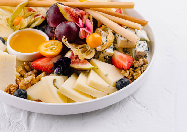 istock Gourmet cheese platter with fresh fruit and honey 2151242088