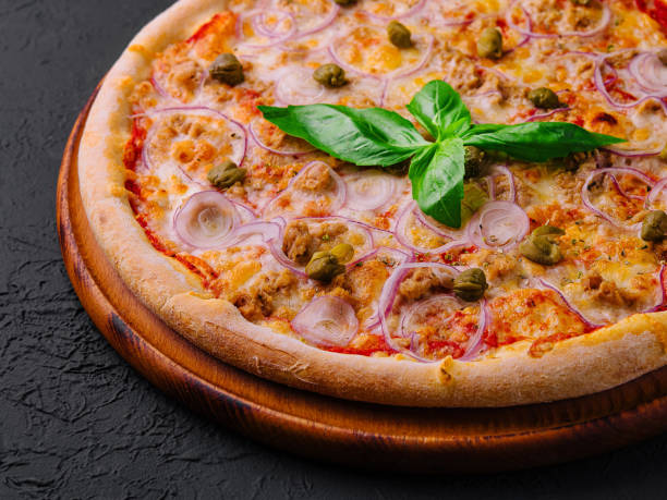 istock Fresh italian pizza on wooden board 2151242123