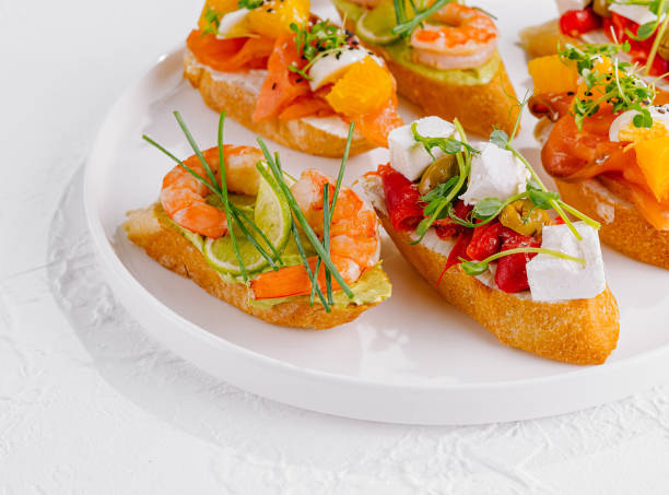 istock Elegant platter of assorted bruschetta with fresh toppings on a white background 2151242171