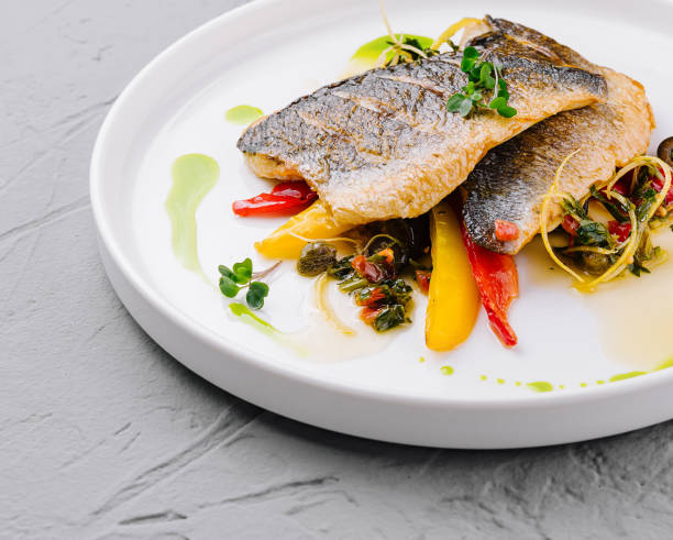 istock Gourmet pan-seared fish with vegetable garnish 2151242191