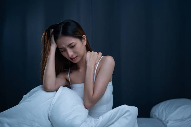 istock Waking up with a headache has problem with structural posture She had neck and shoulder pain. Beautiful woman can't sleep moving restless on bed. Young woman having bad dream 2151243864