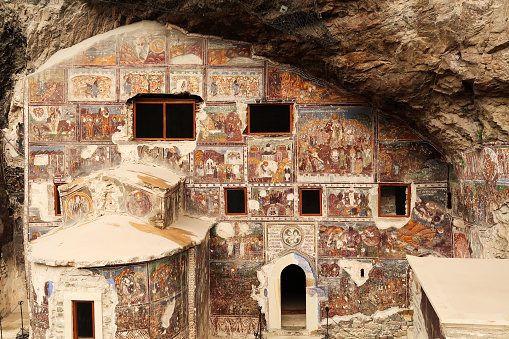 View onto the full, entire front facade of the Rock Church at the Sumela, Sümela Monastery, completely covered in colorful frescos, Trabzon, Turkey 2022