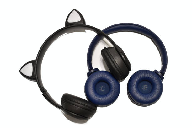 istock Two black wireless headphones lie on a white background. 2151244239