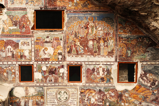 Windows and colorful frescos on the front facade of the Rock Church at the Sumela, Sümela Monastery, completely covered in colorful frescos, Trabzon, Turkey 2022