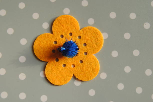 Yellow paper flower with blue sparkle