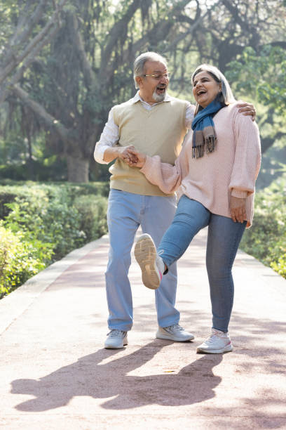istock Happy senior couple spending leisure time in park. 2151244399