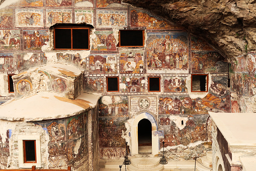 View onto the full, entire colorful front facade of the Rock Church at the Sumela, Sümela Monastery, completely covered in colorful frescos, Trabzon, Turkey 2022