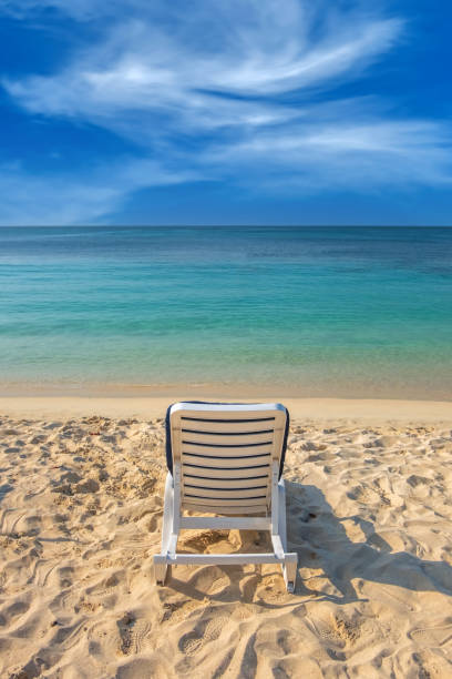 Folding canvas beach chair and bucket hat by Atlantic Ocean at beach in at resort town Spring Lake, New Jersey, USA