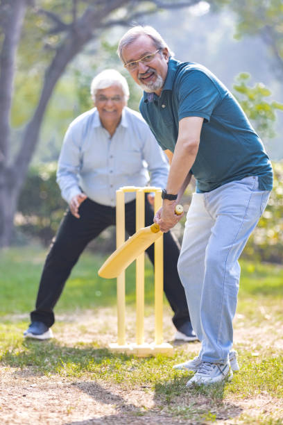 istock senior citizens playing cricket in the park. 2151246594