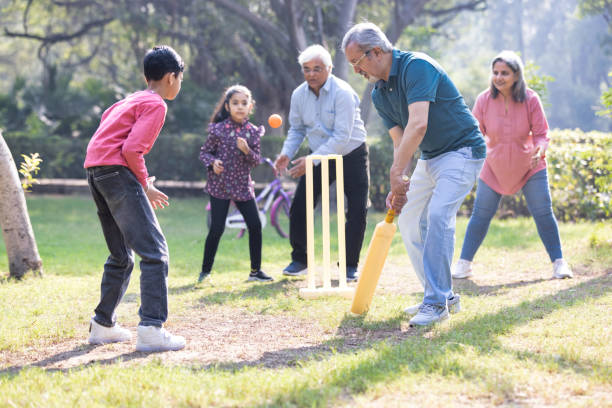 istock Family playing cricket in park 2151246599