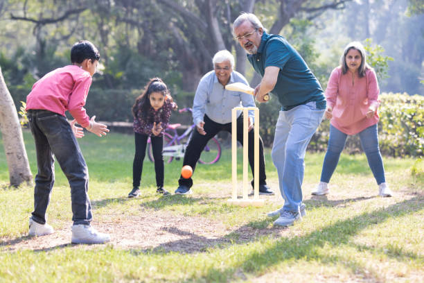 istock Family playing cricket in park 2151246600
