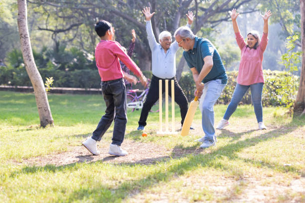 istock Family playing cricket in park 2151246608