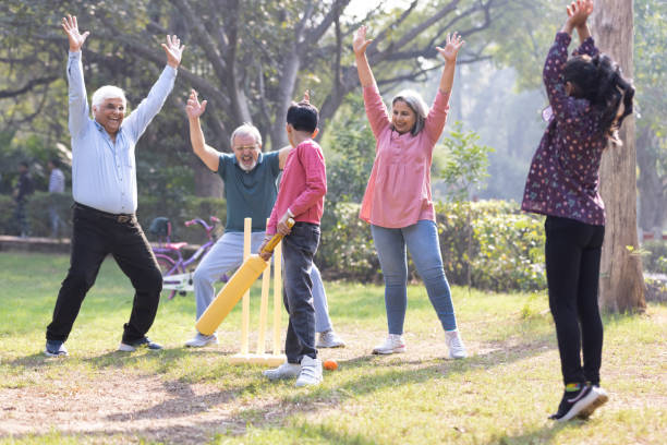 istock Family playing cricket in park 2151246698