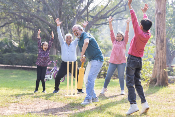 istock Family playing cricket in park 2151246699