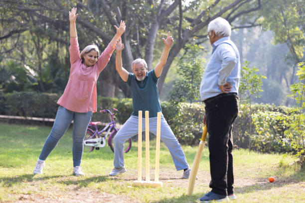 istock senior citizens playing cricket in the park. 2151246722