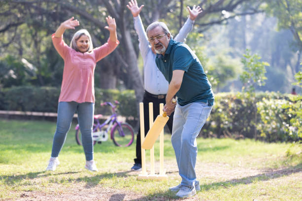 istock senior citizens playing cricket in the park. 2151246724