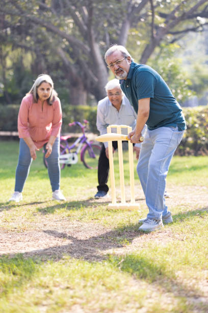 istock senior citizens playing cricket in the park. 2151246728