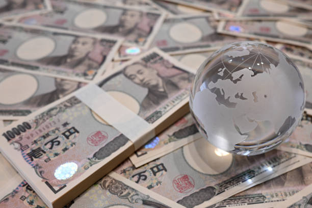 istock 10,000 yen bills and a glass globe 2151248336