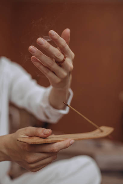 Woman doing aromatherapy with incense stick