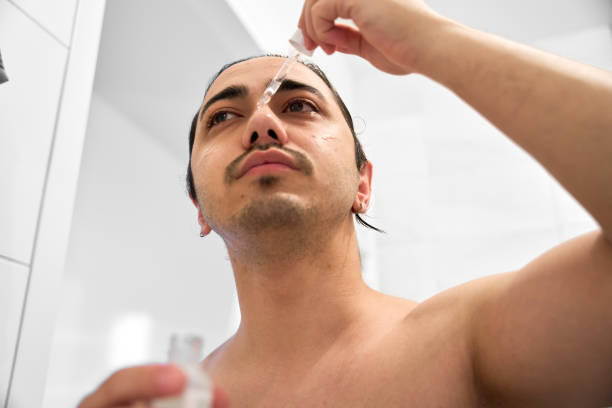 istock Young man is doing his daily skin care routine. 2151250454