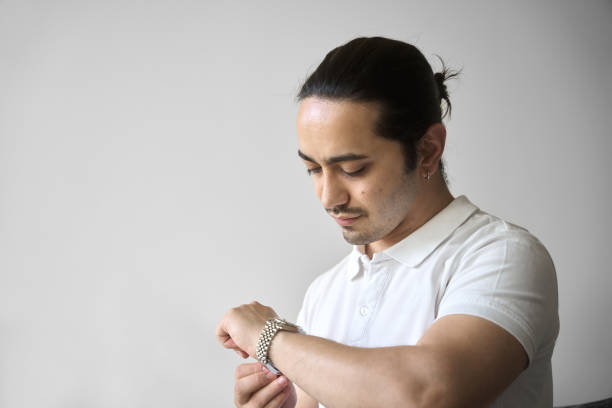 istock young man is looking his watch 2151250599