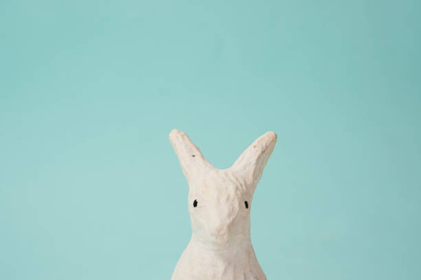 istock Festive white rabbit toy on a blue background with pastel colors Easter 2151251895