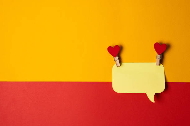 istock yellow sticky notes with wooden clothespins red hearts bicolor background Copy space 2151251967