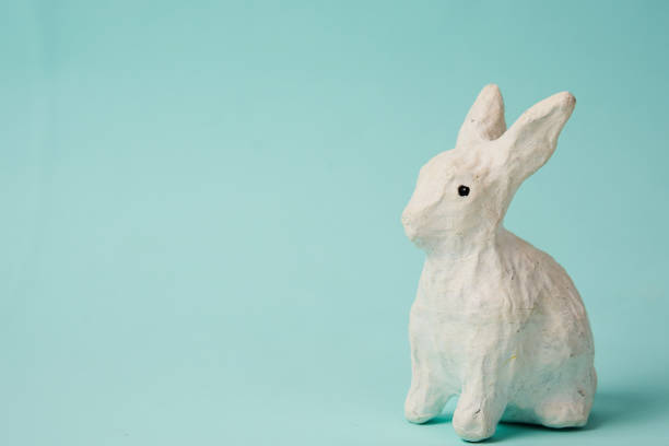 istock Festive white rabbit toy on a blue background with pastel colors Easter 2151252212