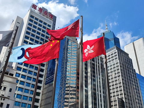Flags against skyscrapers in Hong Kong Central district.