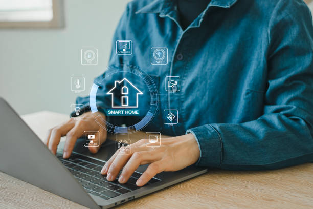 istock Smart home control concept. remote home control online home automation system. Businessman touching smart home icon on virtual screen. 2151254022