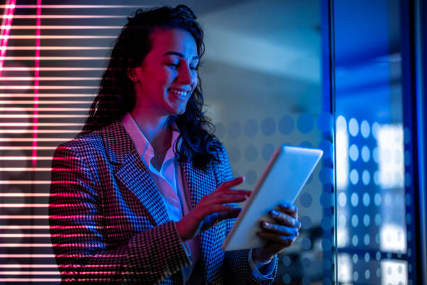 istock Young female entrepreneur with tablet working in virtual office. Woman touching virtual screen. Woman with VR  glasses working in office. 2151254936
